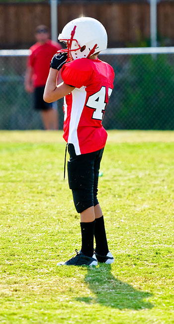 Boy in protective football gear