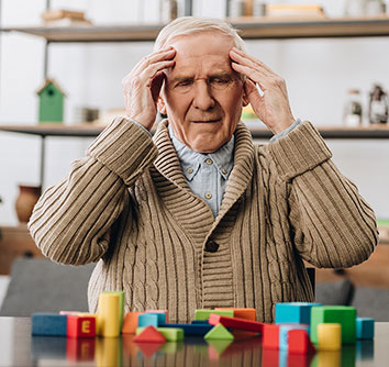 Old man confused with blocks