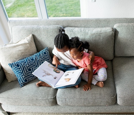 Two girls reading a book