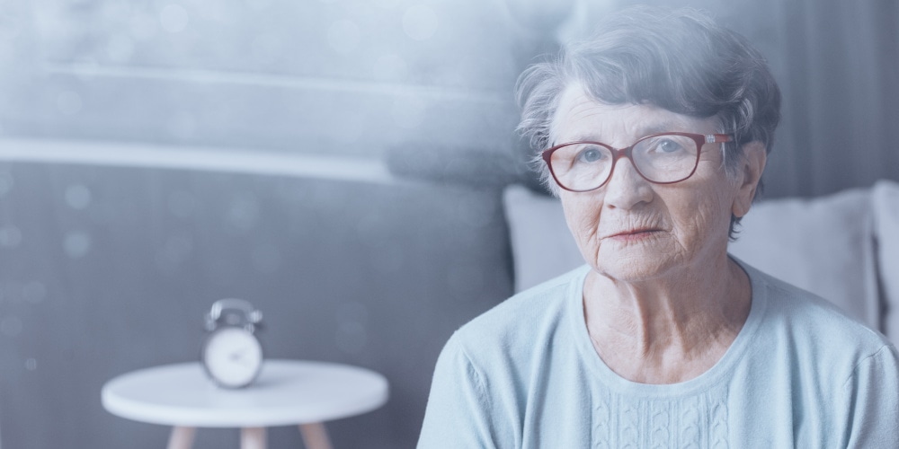 Elderly woman in glasses surrounded by fog