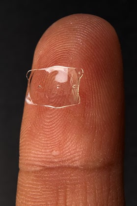Implantable Contact Lens (ICL) held on a finger