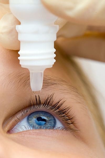 Close up of eye receiving eye drops