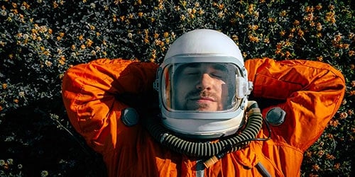 Patient wearing space helmet outdoors for vision testing.
