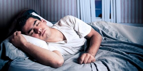 Young boy sleeping peacefully in bed, eye health and vision care focus.