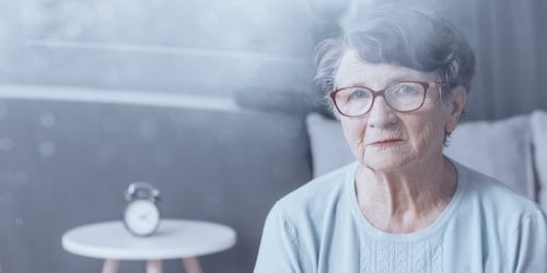Highly experienced elderly woman with glasses at Assil Gaur Eye Institute for advanced eye treatment.