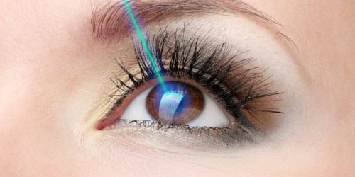 Close-up of eye with advanced laser treatment equipment.