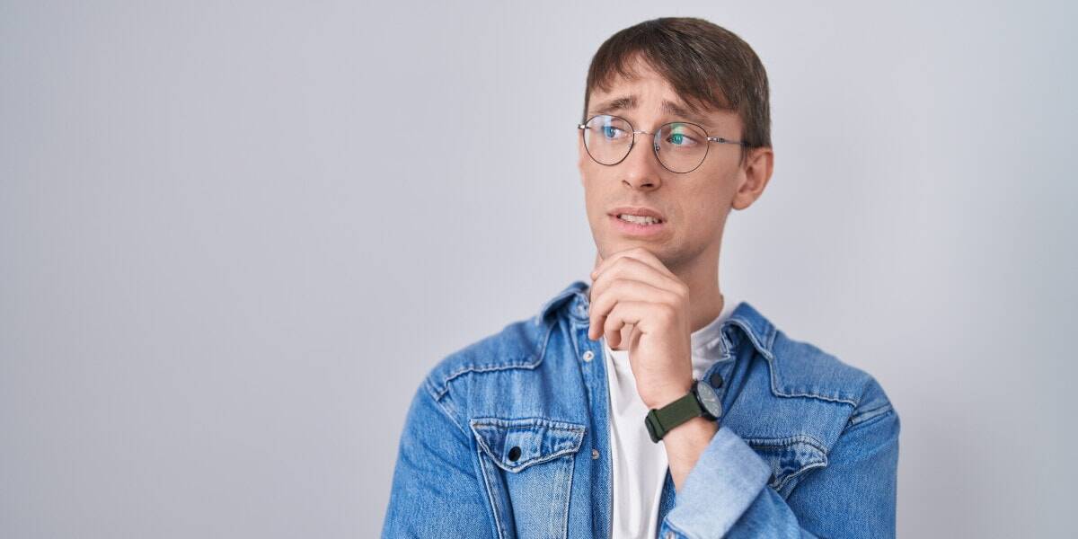 Young man with glasses considering eye health solutions at Assil Gaur Eye Institute.