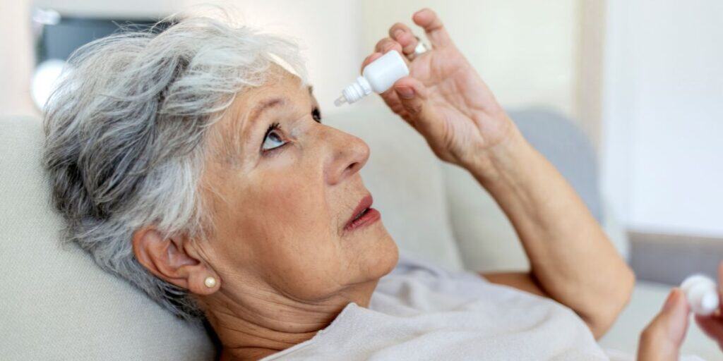 Old woman using eye drops, eye care treatment, senior eye health, Assil Gaur Eye Institute.
