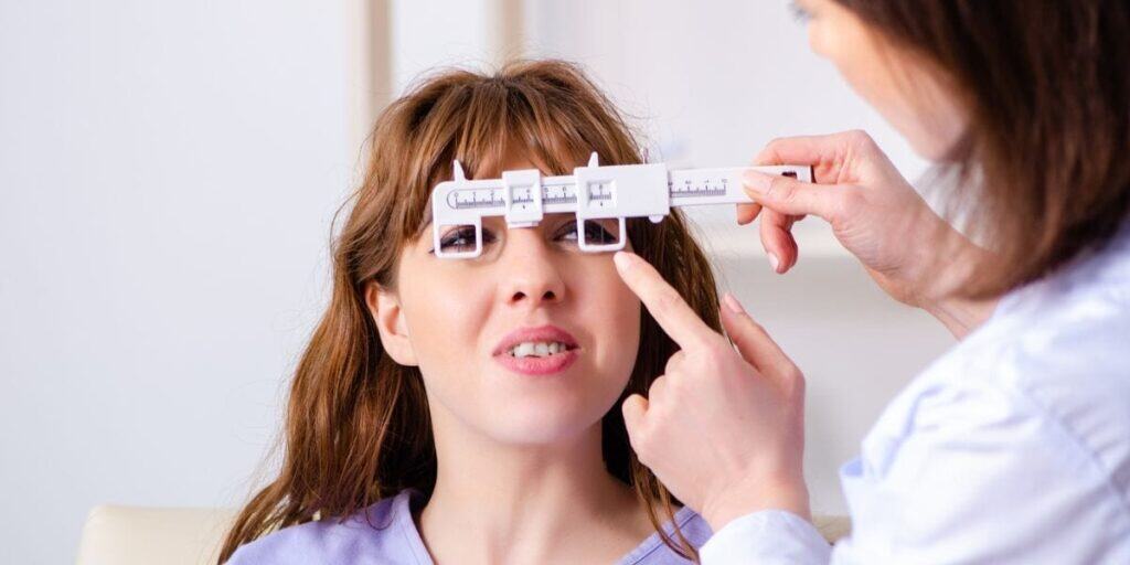 Optometrist conducting eye measurement during eye exam at Assil Gaur Eye Institute, quality eye care.