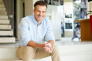 Bright smiling man in a hospital setting, healthcare professional at Assil Gaur Eye Institute.