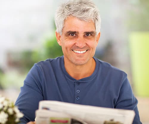 Man reading after cataract surgery, Assil Gaur Eye Institute Los Angeles Middle-aged-man-smiling