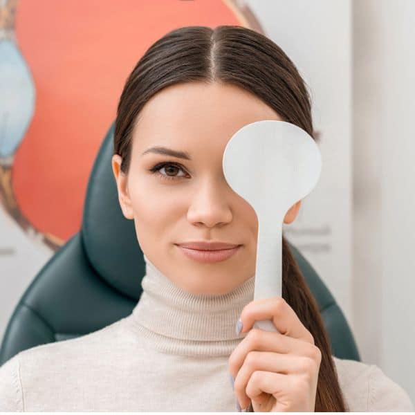 Woman holding eye exam paddle at Assil Gaur Eye Institute in Los Angeles.