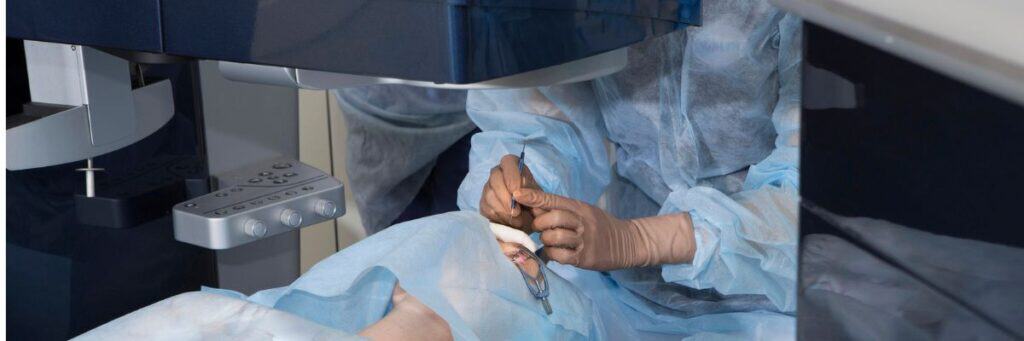 Surgeon performing eye surgery in a modern clinic setting.