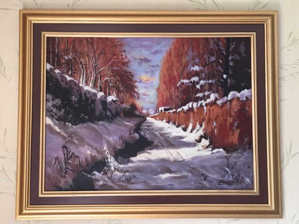 Winter landscape painting of a snowy river with trees in fall colors.