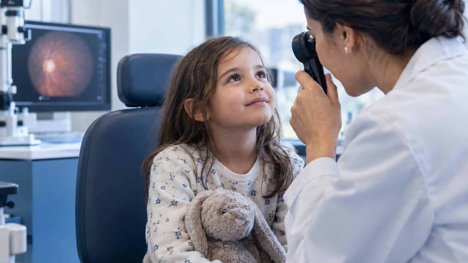 Child undergoing eye exam with doctor at Assil Gaur Eye Institute.